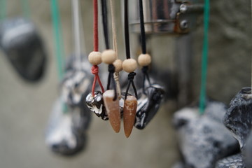 Lucky charm baltic sea hag stone necklaces hanging on a street display for sale with honesty box  