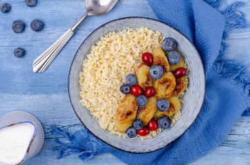 Wheat porridge with fruit and berries