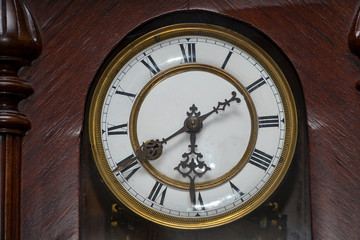 Fototapeta premium Dial of old wooden wall clock with Roman numerals