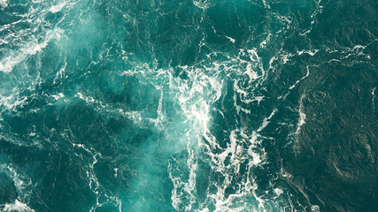 Background of the sea, clean deep ocean with air bubbles, foam on the surface of the ocean. foam composition on blue turquoise water.