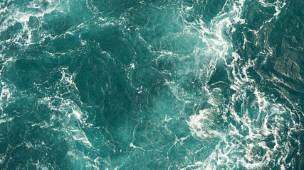 Background of the sea, clean deep ocean with air bubbles, foam on the surface of the ocean. foam composition on blue turquoise water.
