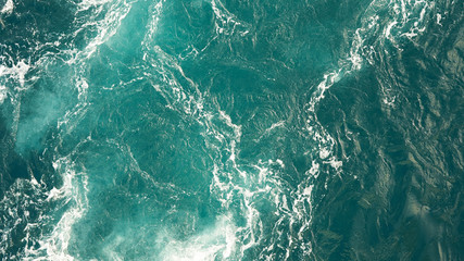 Background of the sea, clean deep ocean with air bubbles, foam on the surface of the ocean. foam composition on blue turquoise water.