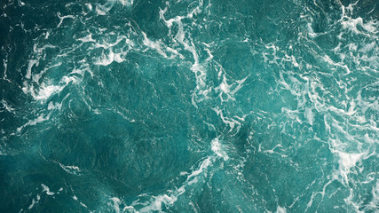 Background of the sea, clean deep ocean with air bubbles, foam on the surface of the ocean. foam composition on blue turquoise water.