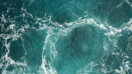 Background of the sea, clean deep ocean with air bubbles, foam on the surface of the ocean. foam composition on blue turquoise water.