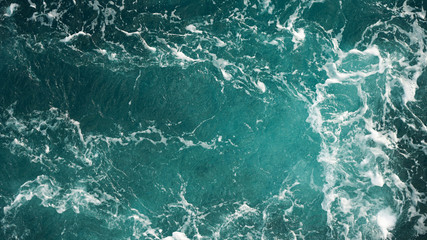 Background of the sea, clean deep ocean with air bubbles, foam on the surface of the ocean. foam composition on blue turquoise water.