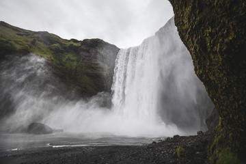 Skogafoss Iceland famous waterfall. Powerful stream, dramatic view with nobody. Icelandic golden ring main landmark.