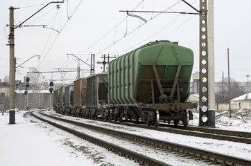 Fototapeta na wymiar railroad hopper cars parked on rural tracks all by themselves on a cold winter day.