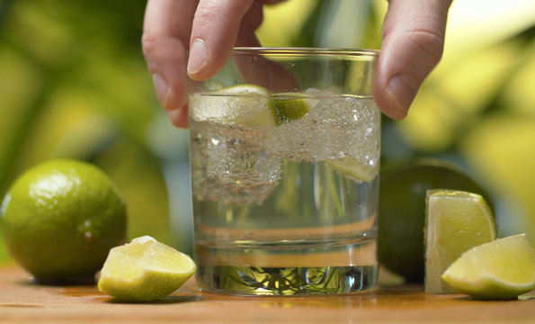 Hand Shaking A Glass Of Soda Water