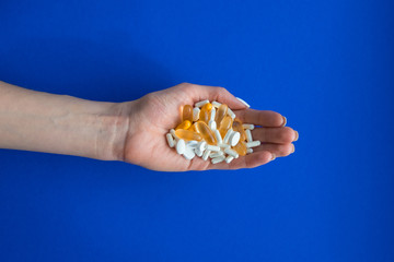 Assorted pills on a blue background. Medication. thermometer.  Flu Prevention. coronavirus mask