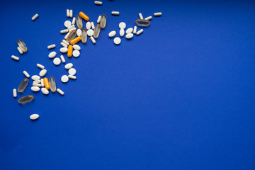 Assorted pills on a blue background. Medication. thermometer.  Flu Prevention. coronavirus mask