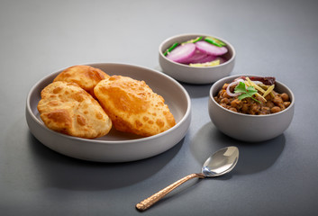 choley bhature is a dish originated initially in the northern part of the Indian subcontinent.  It is a combination of chana masala and bhatura, a fried bread made from maida.