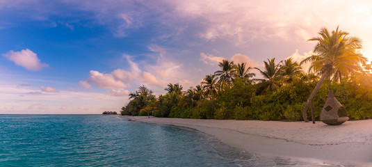 Tranquil tropical beach landscape. Relaxing sunset colors. Beautiful sunset over the sea with a...