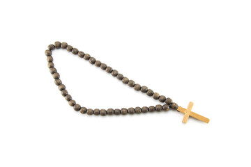 Handmade dark brown wooden rosary with a light cross. Religious subject for counting prayers. A religion accessory from round bu sins. White isolated background.