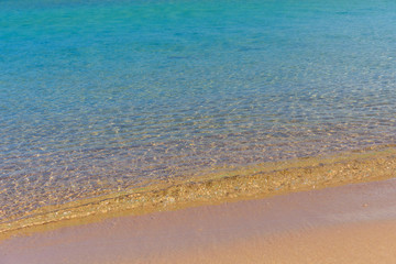 Closeup of the sand on beach and Red sea water