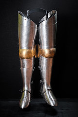 Real knight armor for legs on a black.