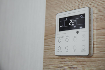 air conditioner screen on the wall that shows an air temperature of 22 degrees Celsius