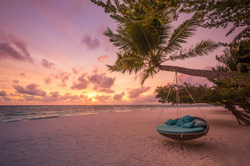 Tropical beach sunset as summer landscape with luxury resort beach swing or hammock and white sand...