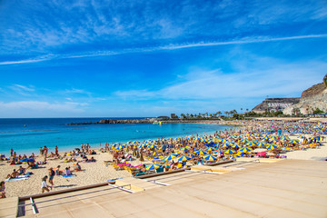 sunny landscape with the picturesque colorful Amadores beach on the Spanish Canary Island of Gran Canaria