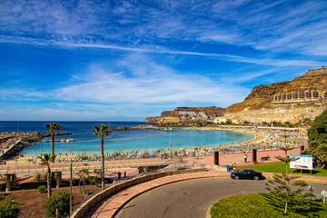 Fototapeta na wymiar sunny landscape with the picturesque colorful Amadores beach on the Spanish Canary Island of Gran Canaria