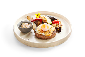 Steak with sous vide egg and baked vegetables