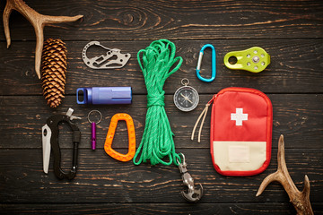 Travel items for hiking over wooden background