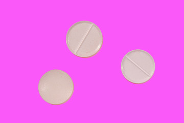 Antibiotic pills on a pink background. Healthcare and medicine concept