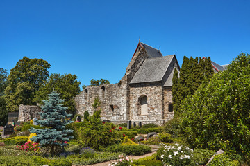 Old Ostermarie Church demolished in 1890 (foreground) and Romanesque style Ostermarie Church from 1891 (background) in Ostermarie village, Bornholm island, Denmark