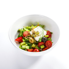 Greek salad in white bowl