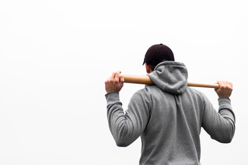 Back view of man holding baseball bat on shoulders