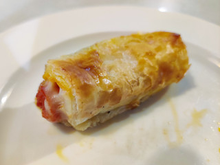 puff pastry top stuffed with ham on white plate