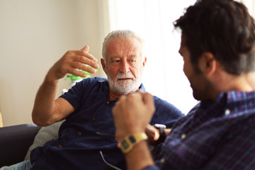 Father and son talking and sharing discussion lifestyle for domestic life at home.