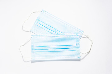 Two sterile medical masks on white background top view. Infection prevention concept. 