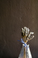 dried lavender tied with a purple bow on test tube