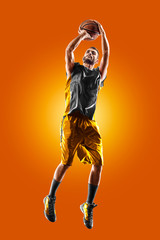 bright professional basketball player on an orange background