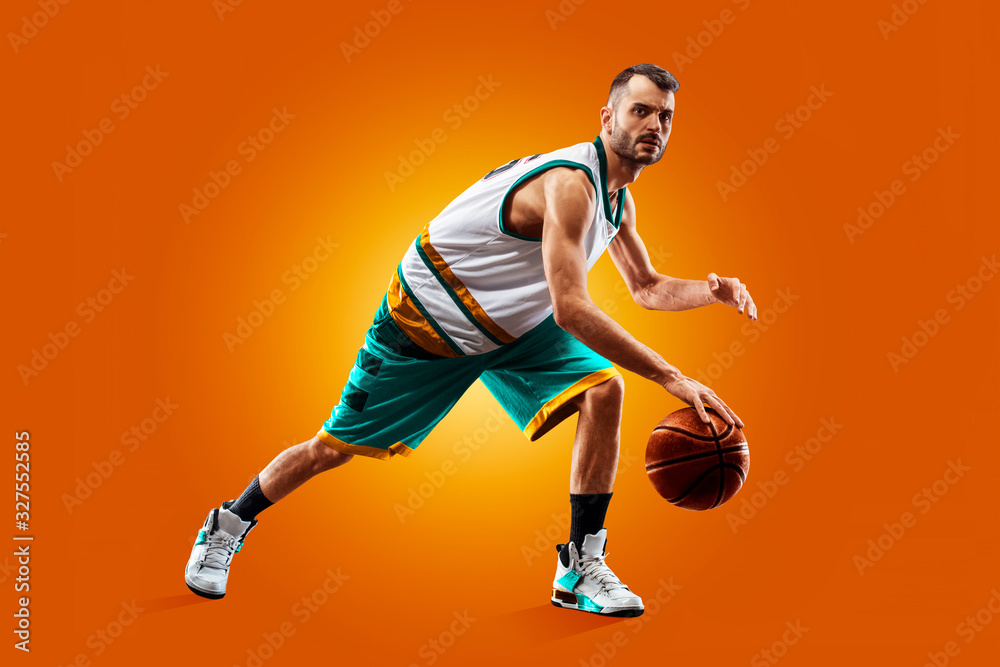 Wall mural bright professional basketball player on an orange background