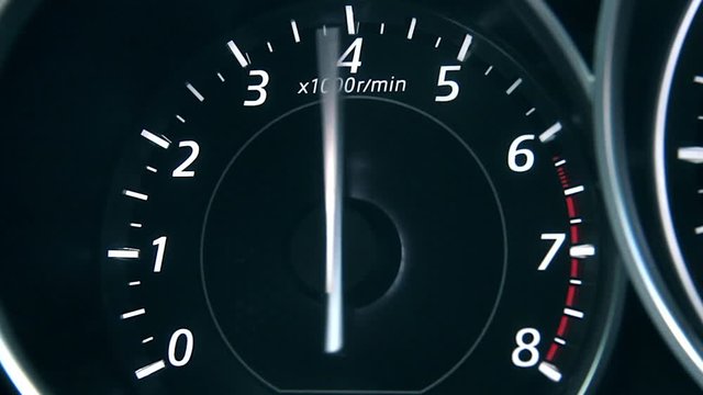Car speedometer and moving,featuring lights leaks, a speedometer, and long exposure time lapse traffic.