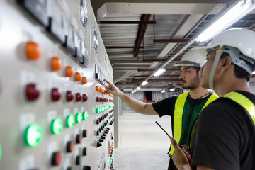 Electrical Engineer team working front HVAC control panels, Technician daily check controls system for security functions in service room at factory. Heating,Ventilation,Air Conditioning.