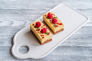 Mango cake. Freeze-dried raspberries and nuts. Raw dessert. Vegetarian healthy food