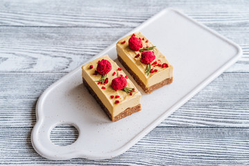 Mango cake. Freeze-dried raspberries and nuts. Raw dessert. Vegetarian healthy food