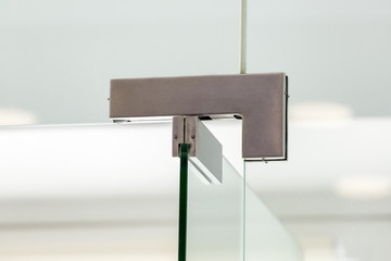 glass door hinges to office, close up of hinged accessories of transparent partitions.