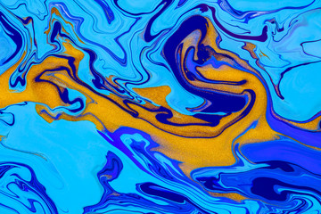 Fluid art texture. Background with abstract swirling paint effect. Liquid acrylic picture that flows and splashes. Mixed paints for website background. Blue, golden and cyan overflowing colors