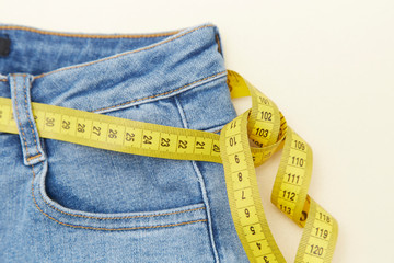 A ruler and red apple for measuring waistline on jeans
