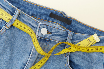 A ruler and red apple for measuring waistline on jeans