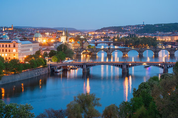 Fototapeta na wymiar View from Letna to Prague city and Charles Bridge that crosses Vltava river, Prague.