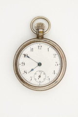 Silver pocket watch that is old and worn