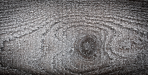 Hoarfrost on a wooden board as a background