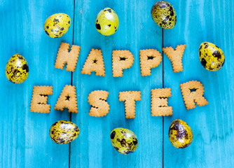 Happy Easter Flat Lay Background with Lettering Cookies and golden eggs.