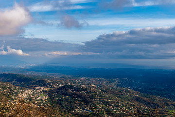 Obraz premium The panoramic view of Côte d'Azur under the cloudy sky and the Meditarrenean sea coastline in the horizon