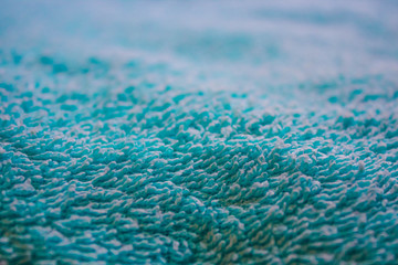 macro photography of blue Terry cloth (close-up texture of a Terry towel) with selective focus