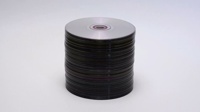 CD and DVD discs. Stack of compact discs on white background. Stop motion animation